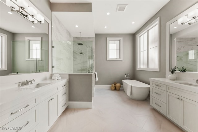 bathroom with independent shower and bath, vanity, and a healthy amount of sunlight