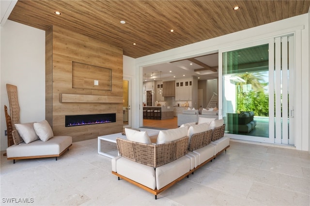 living room featuring wood ceiling and a fireplace