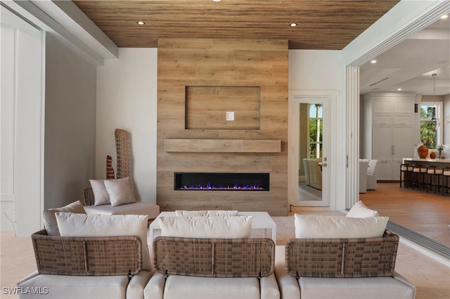 living room with wooden ceiling, a large fireplace, and recessed lighting