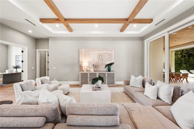 living area featuring beam ceiling, coffered ceiling, light wood finished floors, and baseboards