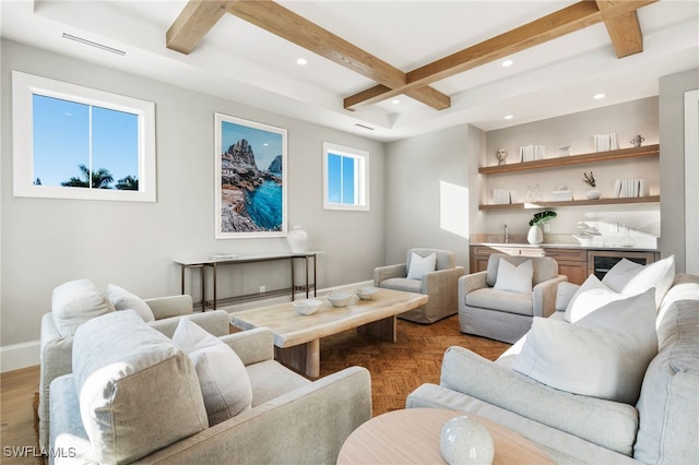 living room featuring beam ceiling, wine cooler, light hardwood / wood-style flooring, and coffered ceiling