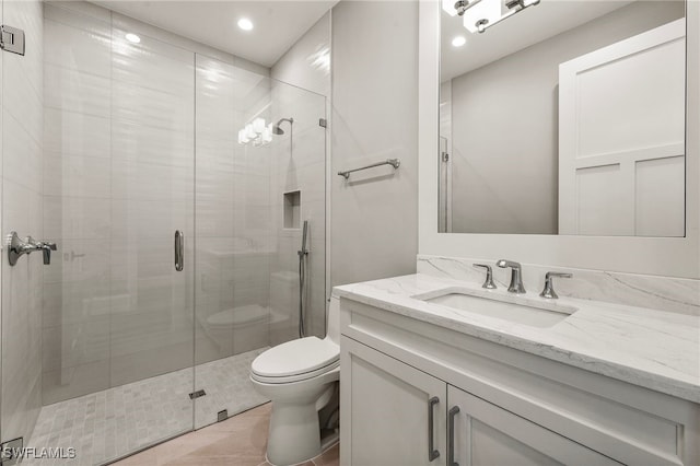 bathroom with tile patterned flooring, vanity, toilet, and an enclosed shower