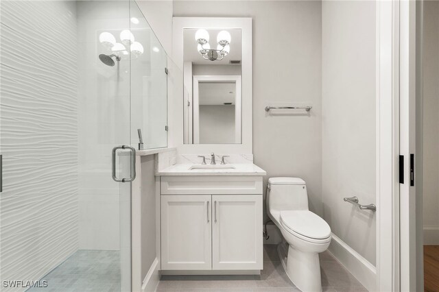 bathroom with a chandelier, vanity, toilet, and walk in shower