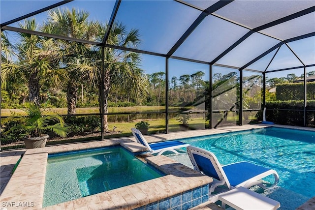 view of pool with a lanai and an in ground hot tub