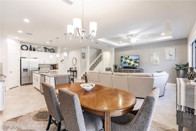 dining area with visible vents, stairs, a tray ceiling, light tile patterned flooring, and recessed lighting