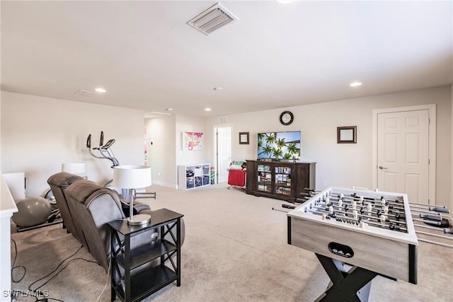 recreation room with light colored carpet