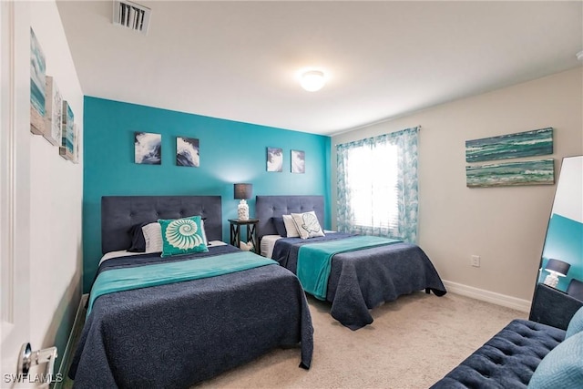 carpeted bedroom featuring baseboards and visible vents