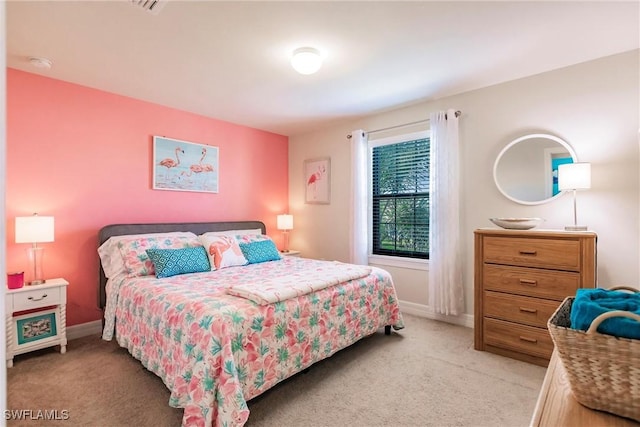 bedroom featuring light carpet and baseboards