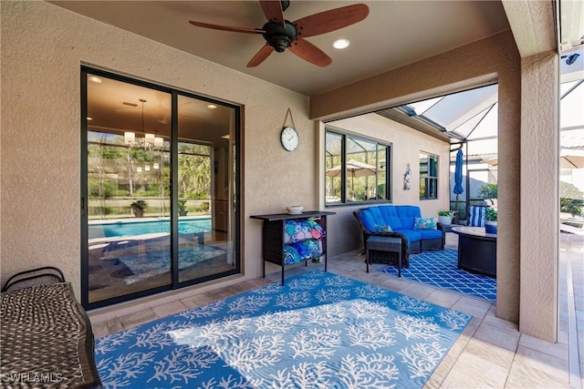 view of patio / terrace with a lanai, ceiling fan, and an outdoor hangout area