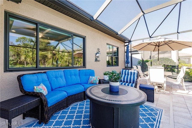 view of patio / terrace featuring glass enclosure and an outdoor hangout area