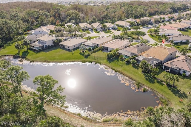 bird's eye view with a water view, a residential view, and a wooded view