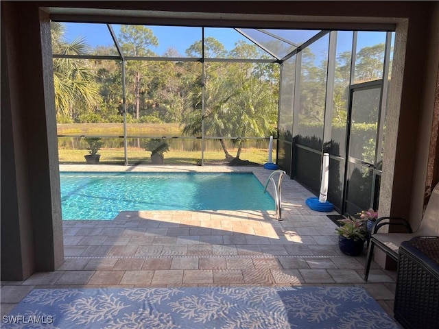 view of swimming pool with a patio and a lanai