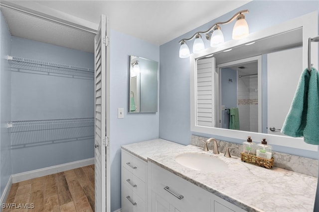 bathroom with hardwood / wood-style flooring and vanity