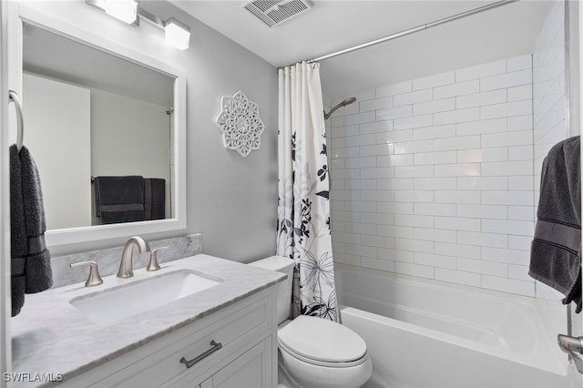 full bathroom featuring shower / bath combo, vanity, and toilet