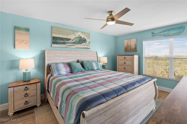 bedroom with hardwood / wood-style floors and ceiling fan