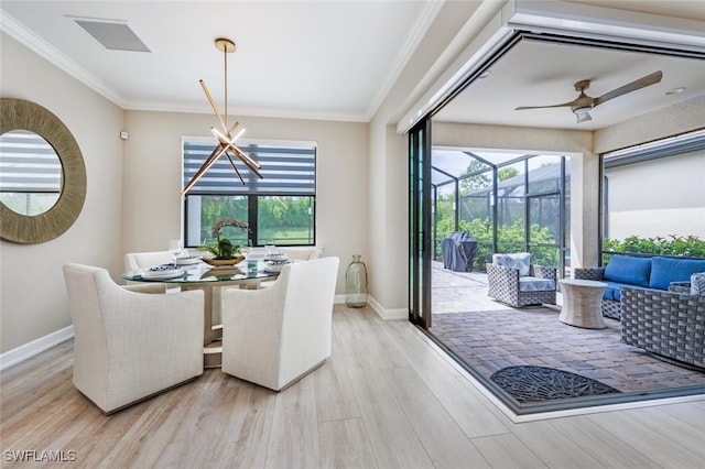 dining room with ornamental molding, a wealth of natural light, a sunroom, and wood finished floors