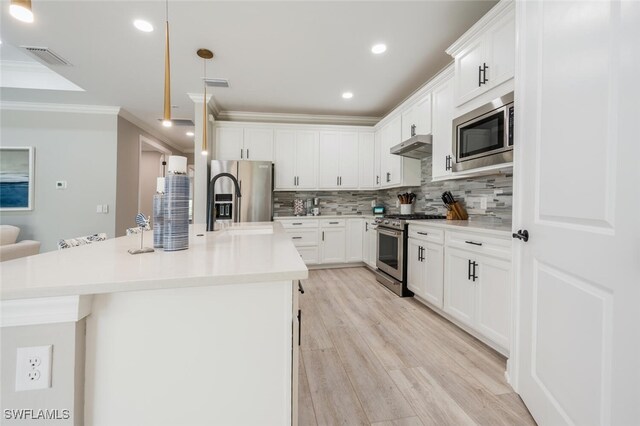 kitchen featuring appliances with stainless steel finishes, white cabinetry, crown molding, and an island with sink