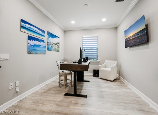 office with light wood-type flooring and ornamental molding