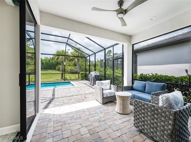 view of patio featuring a lanai, ceiling fan, and outdoor lounge area