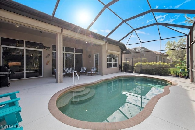 view of swimming pool featuring a grill, a patio, and glass enclosure