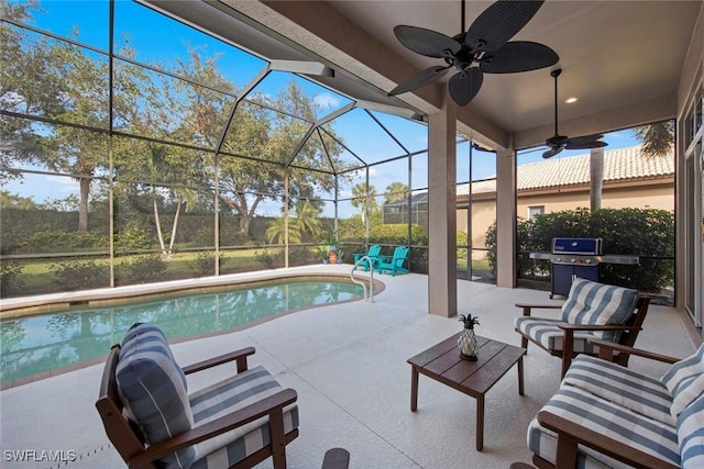 view of patio featuring a grill, an outdoor hangout area, ceiling fan, and glass enclosure