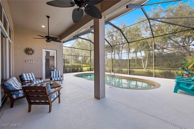 view of pool with a lanai, ceiling fan, and a patio area