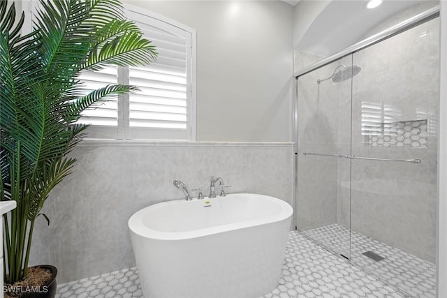 bathroom with tile patterned flooring and plus walk in shower