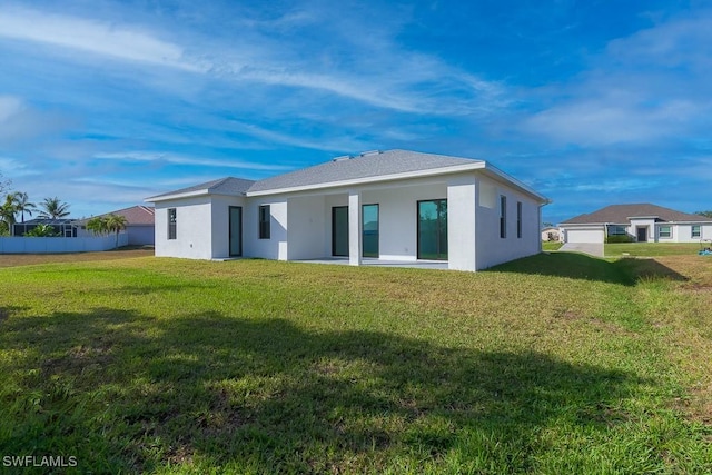 rear view of house with a yard