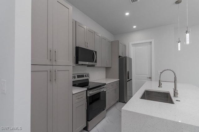 kitchen with stainless steel appliances, gray cabinets, hanging light fixtures, and sink