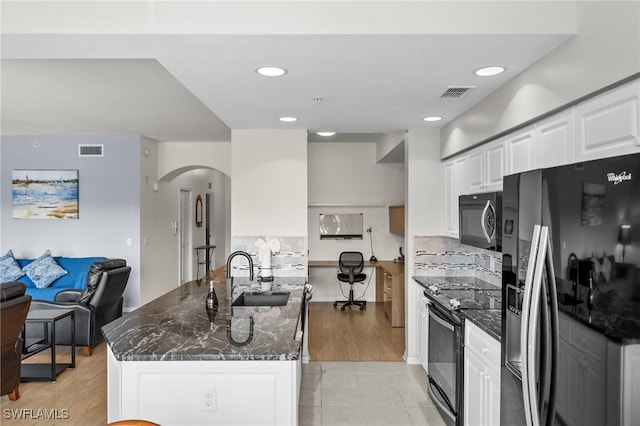 kitchen featuring black range with electric stovetop, white cabinetry, sink, a center island, and stainless steel refrigerator with ice dispenser