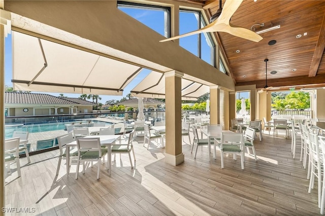 wooden deck featuring ceiling fan and a community pool