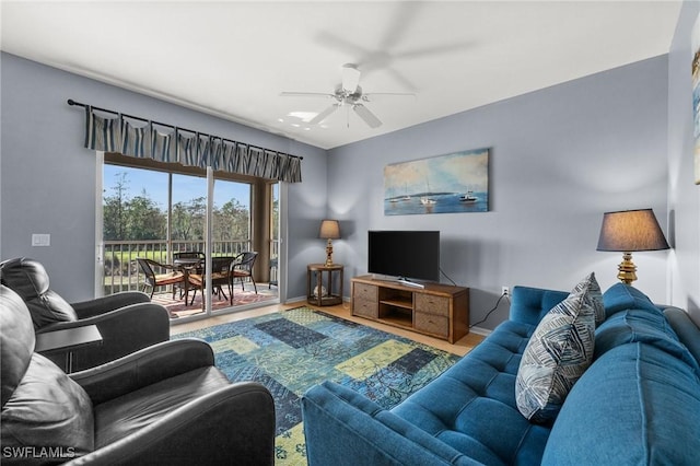 living room with wood-type flooring and ceiling fan