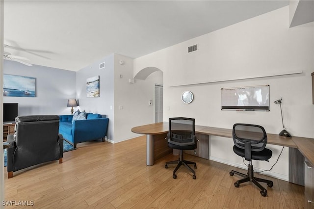 office area featuring built in desk, light hardwood / wood-style floors, and ceiling fan