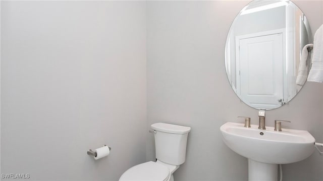 bathroom with toilet and a sink