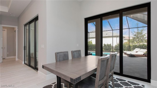 dining space featuring baseboards and light wood-style flooring