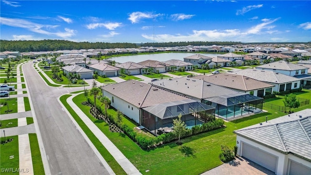 drone / aerial view featuring a residential view and a water view