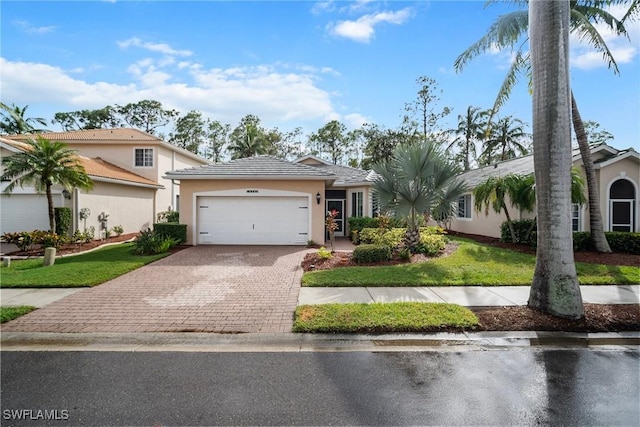 view of front of home with a garage and a front yard