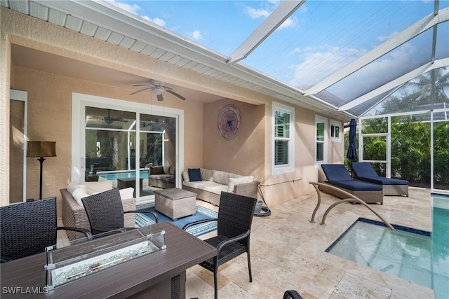 exterior space featuring glass enclosure, an outdoor living space, and ceiling fan