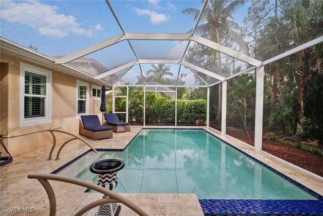 view of pool featuring a patio area and a lanai