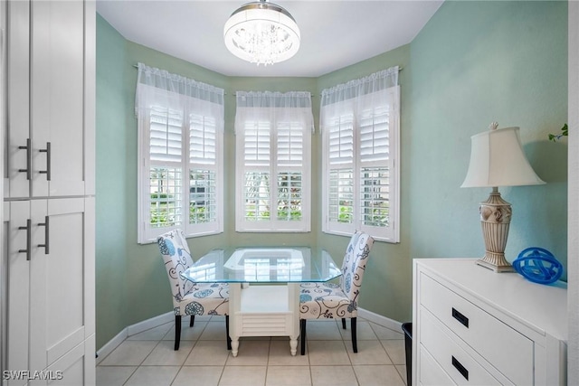 tiled dining space featuring a chandelier