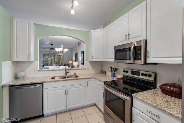 kitchen with sink, white cabinets, and stainless steel appliances