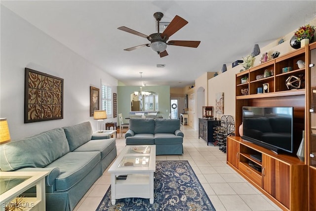 living room featuring light tile patterned floors and ceiling fan with notable chandelier