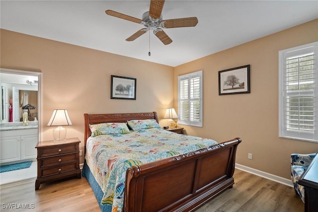 bedroom with connected bathroom, hardwood / wood-style flooring, and ceiling fan