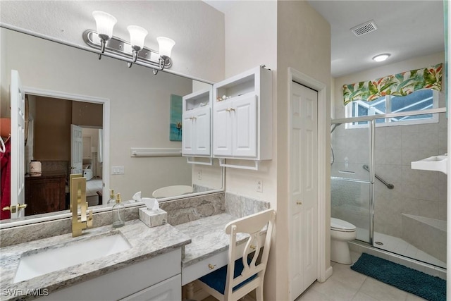 bathroom with tile patterned floors, vanity, toilet, and walk in shower