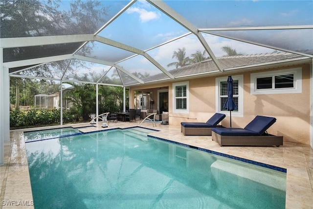 view of swimming pool featuring an outdoor living space, a patio, and a lanai