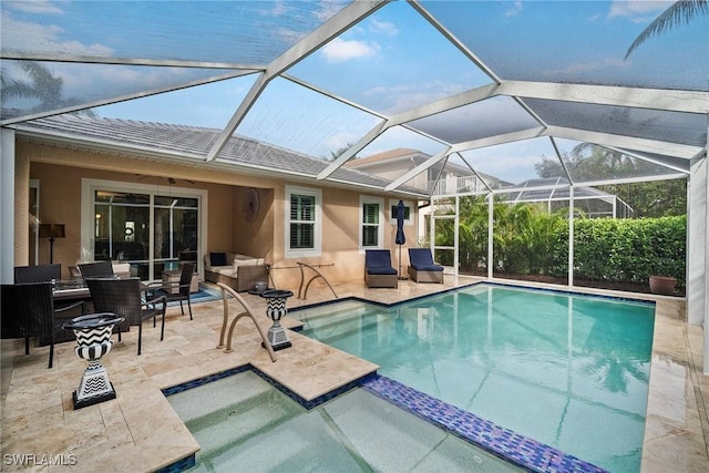 view of swimming pool with glass enclosure, a patio area, ceiling fan, and an outdoor hangout area