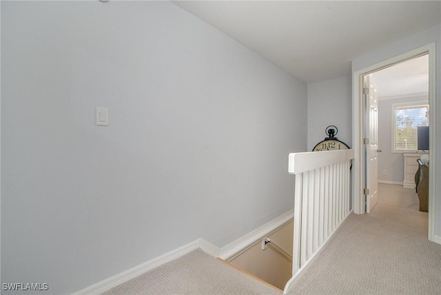 hall with light colored carpet