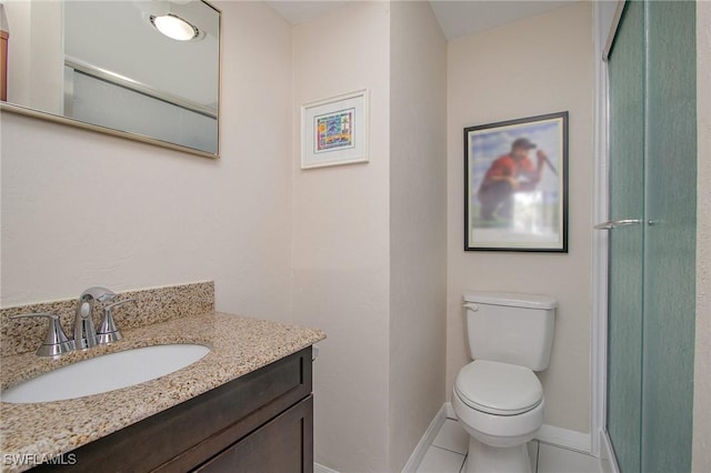 bathroom with tile patterned flooring, vanity, toilet, and walk in shower