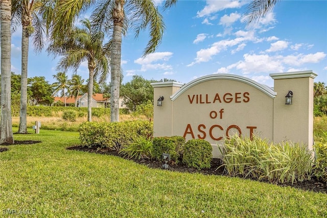 community / neighborhood sign featuring a lawn