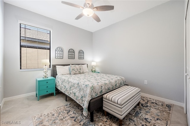 tiled bedroom featuring ceiling fan